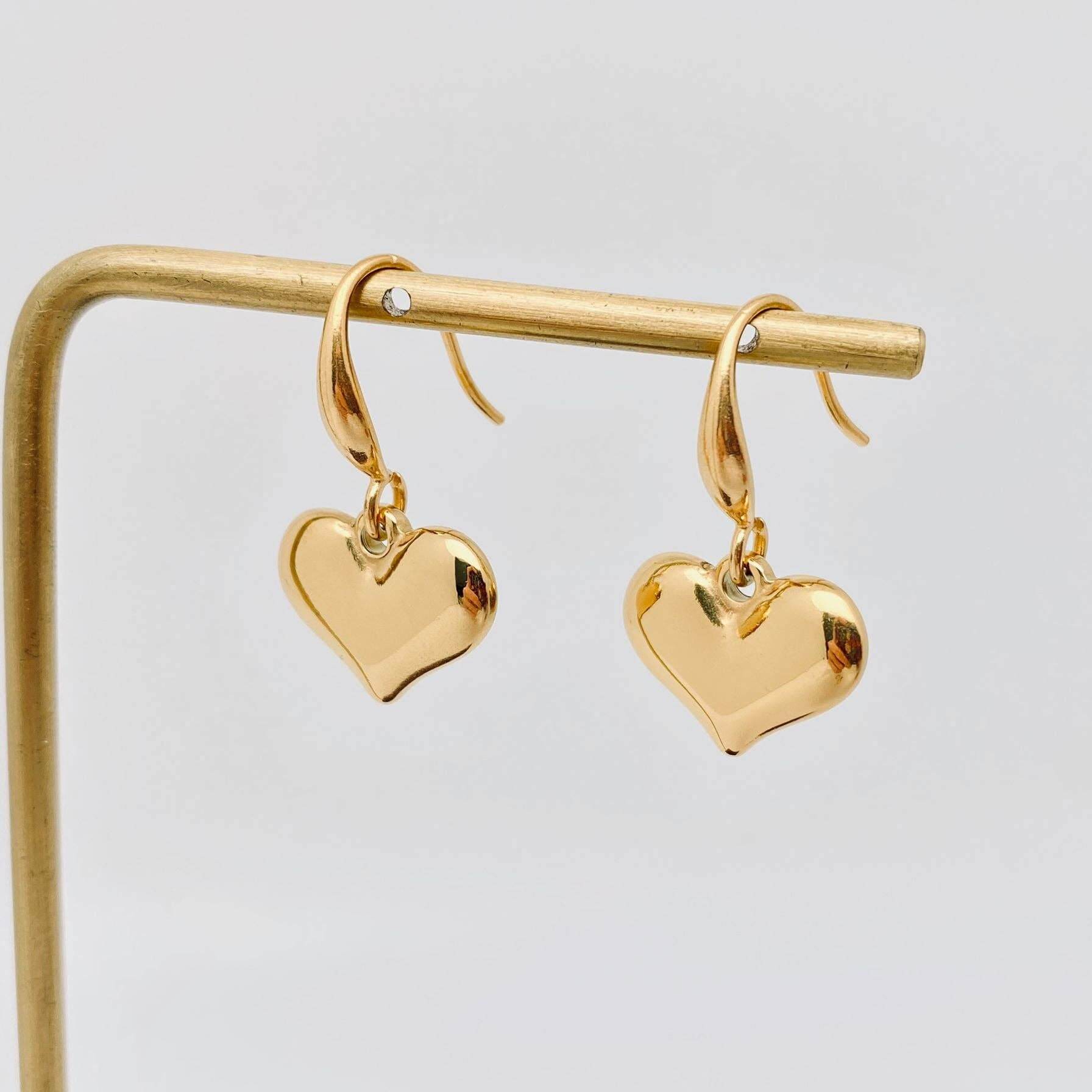Forever Yours Earrings - 18K gold-plated heart drop earrings on a display stand, perfect for everyday wear.