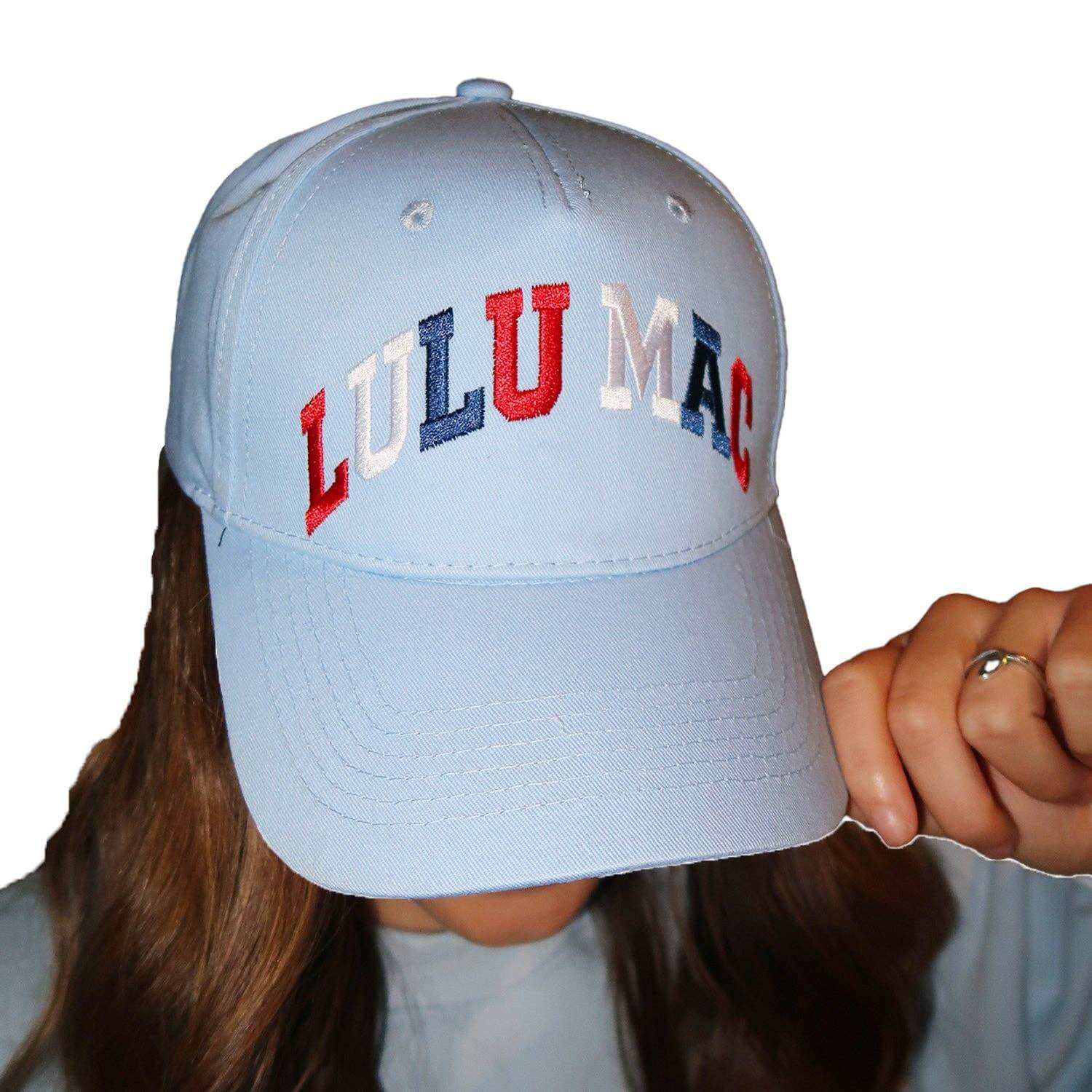 Model wearing a Red White and Lulu (Mac) Hat featuring vibrant red, white, and blue colors for a sporty look.