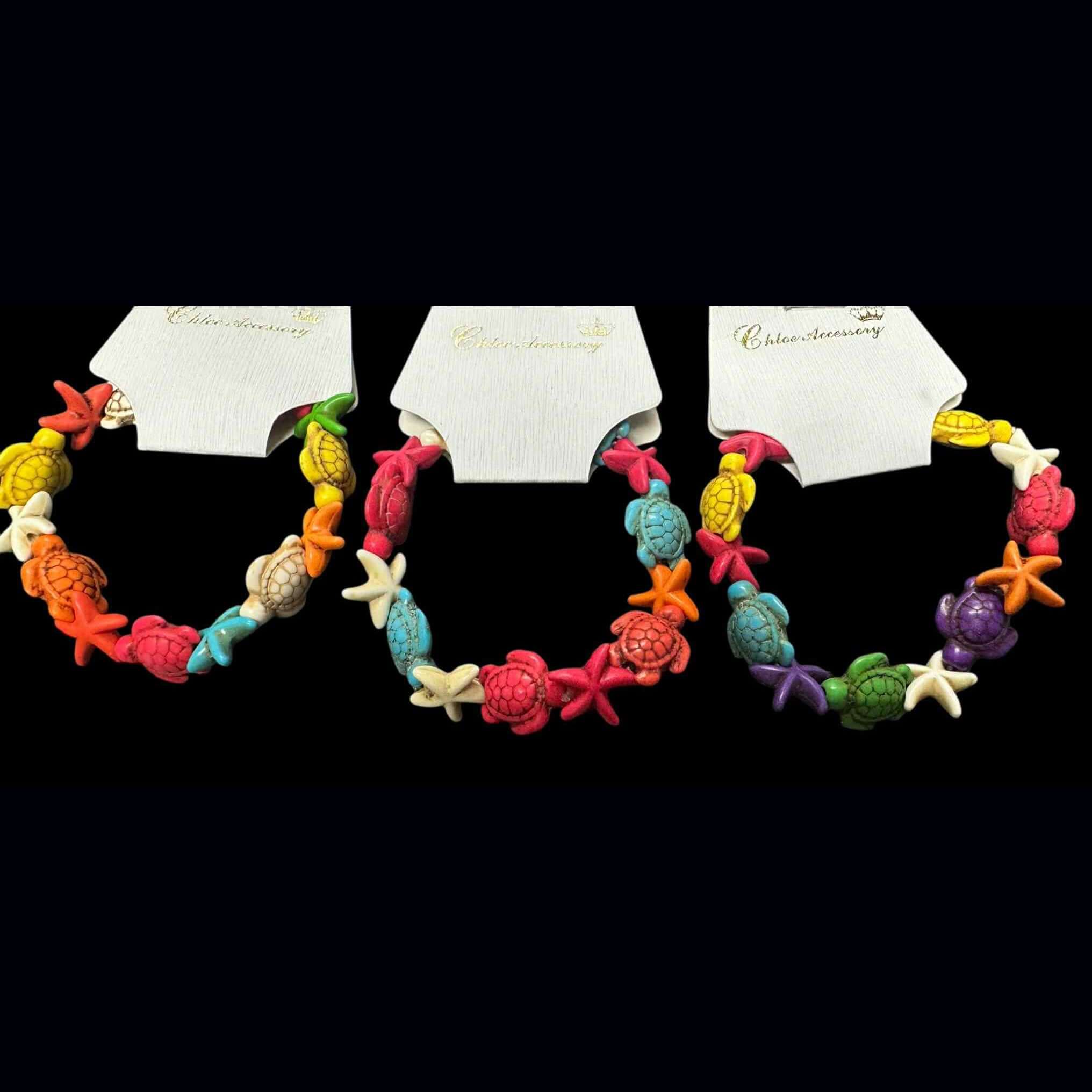 Brightly colored handmade Tidepool Treasures Bracelet featuring turtles, starfish, and shell-shaped beads.