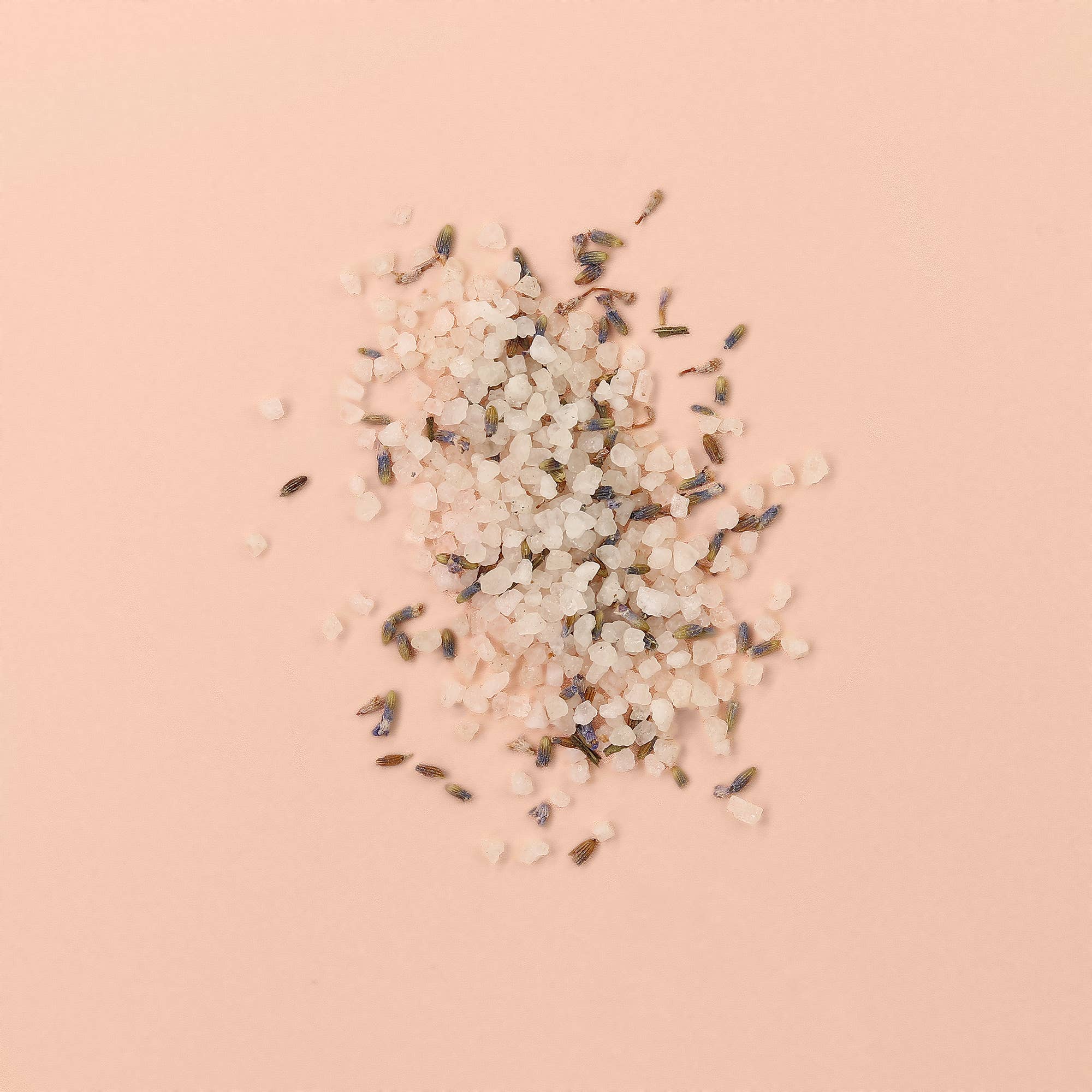 Petal-Infused Effervescent Mineral Bath Salts (Duo Pack) with lavender petals on a pink background.