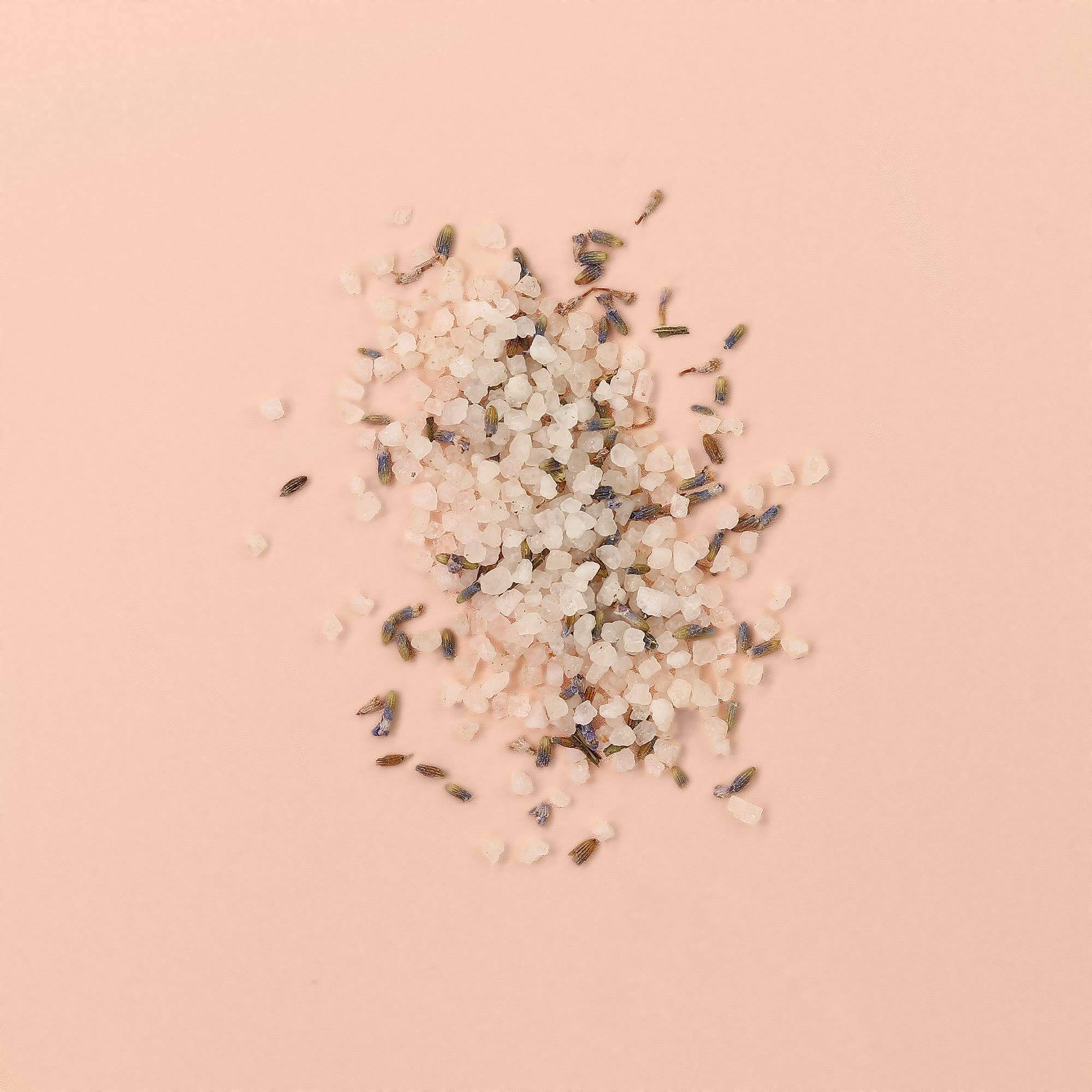 SpaLife Petal-Infused Bath Salts (2 SCENTS) with lavender petals and pink bath salt on a soft pink background.