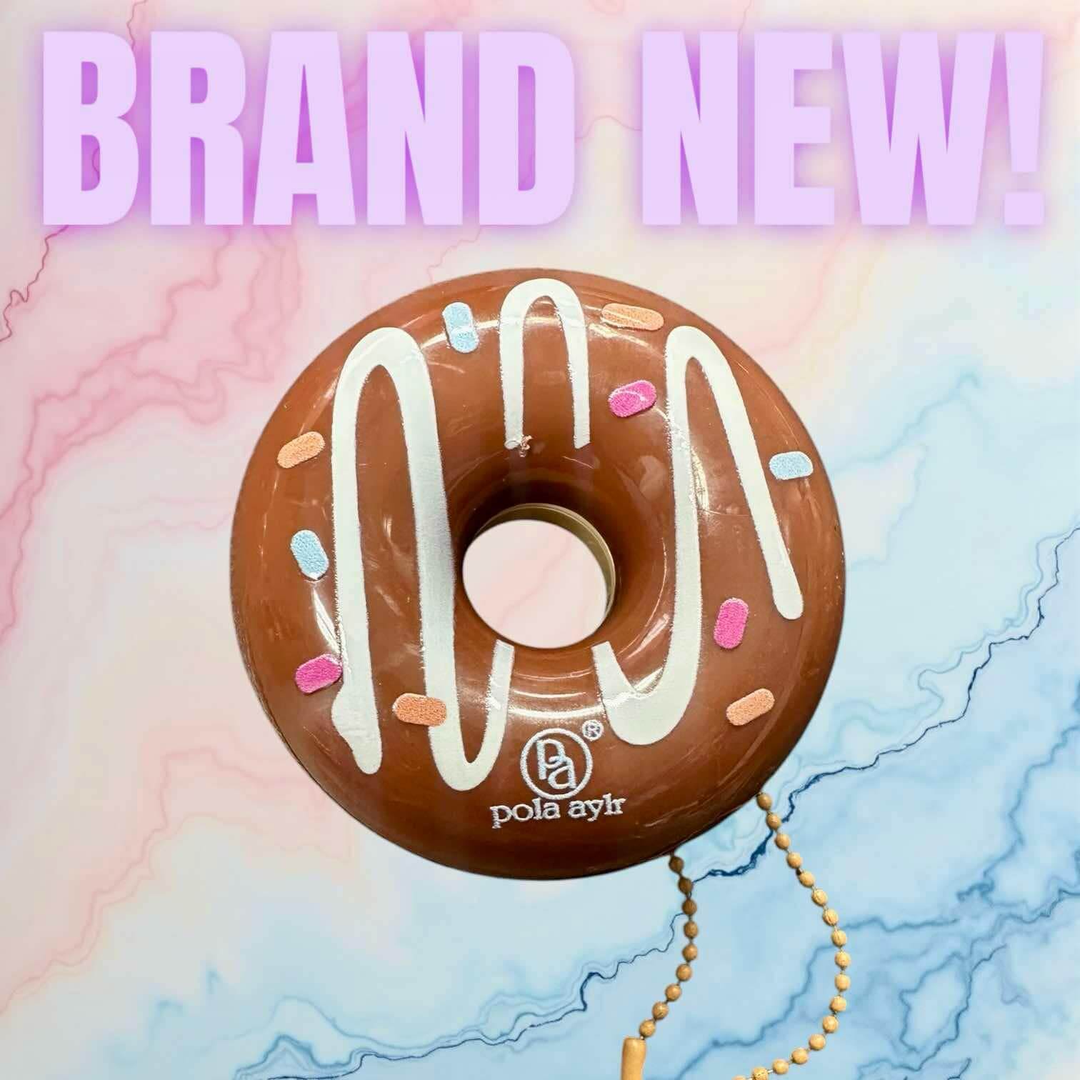 Donut Worry Lip Balm in donut shape, keychain style, highlighting its brand new design and vibrant colors.