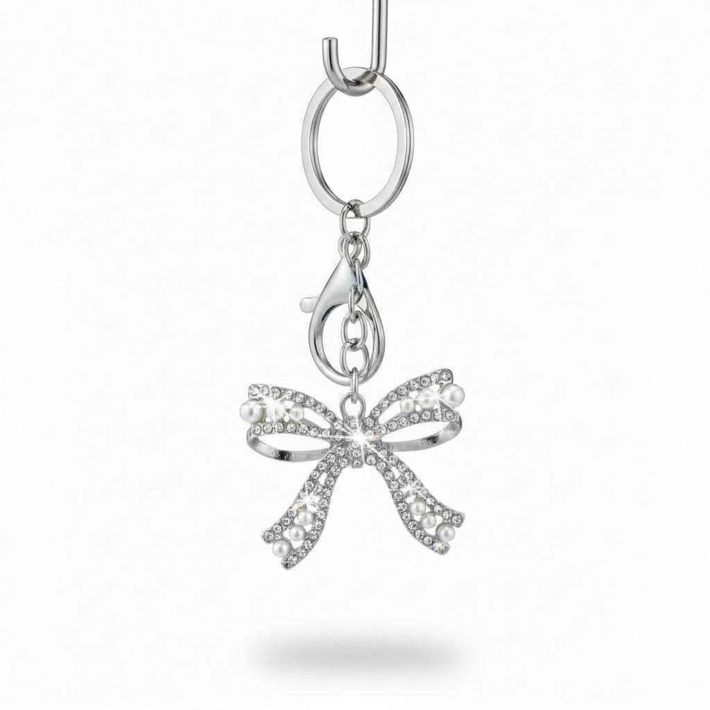 ENCHANTED BOW Bag Charm / Keychain in silver with rhinestones and faux pearls, adding sparkle to bags and key rings.