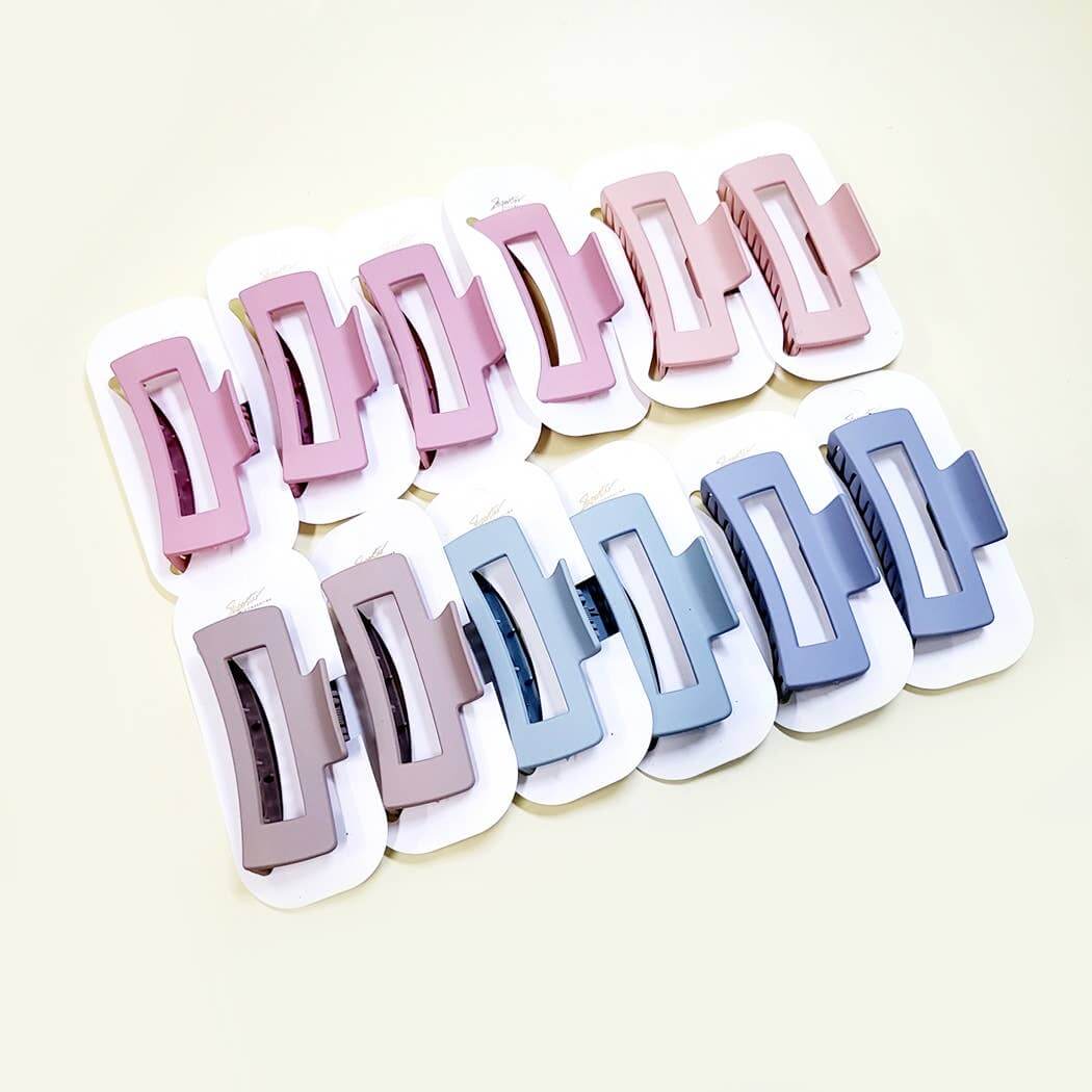 Chic Simplicity large claw clips in pink and blue colors on display, showcasing a sleek matte finish.