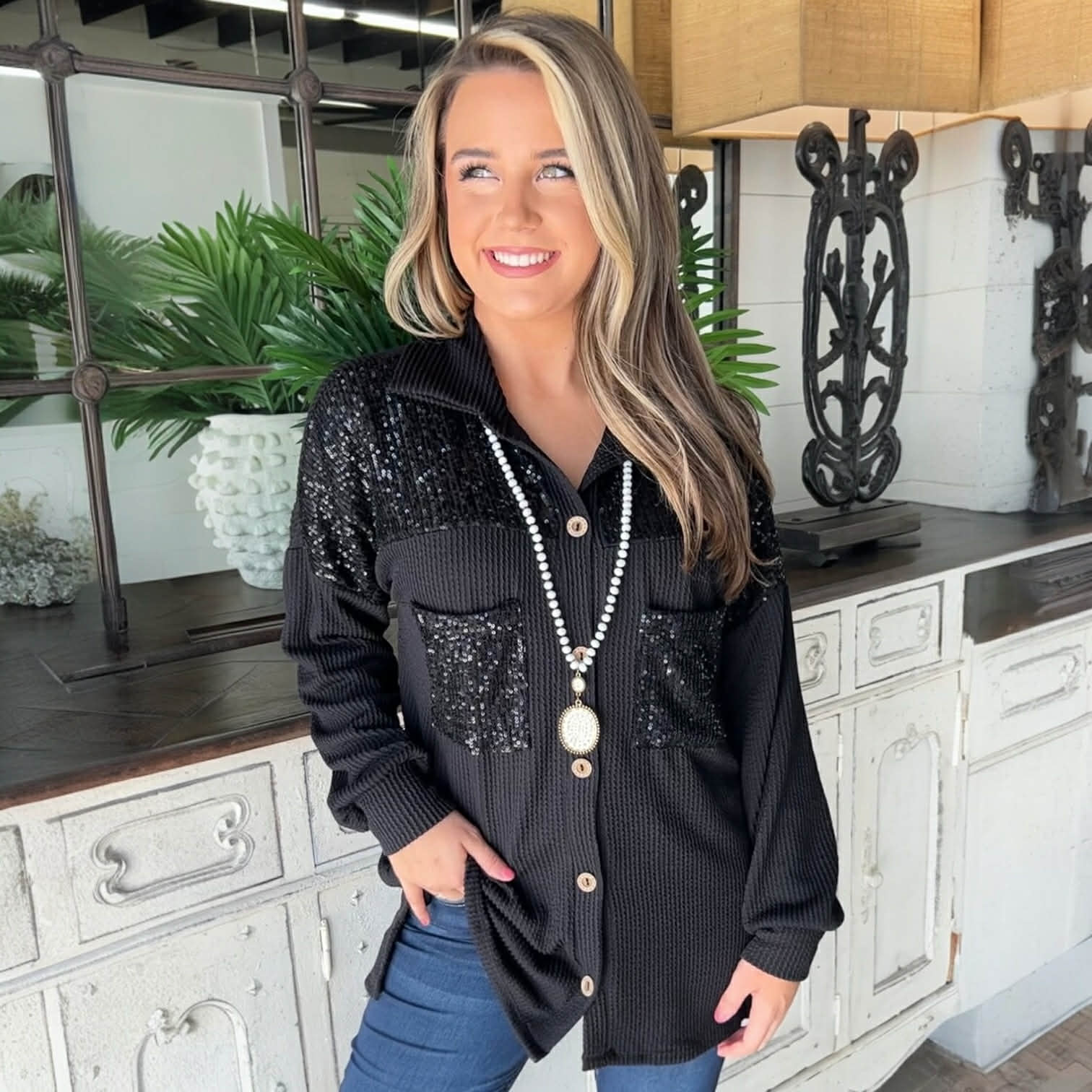 Model wearing CITY LIGHTS TOP, a black corded shacket with sequin patch chest pockets and stylish accessories.