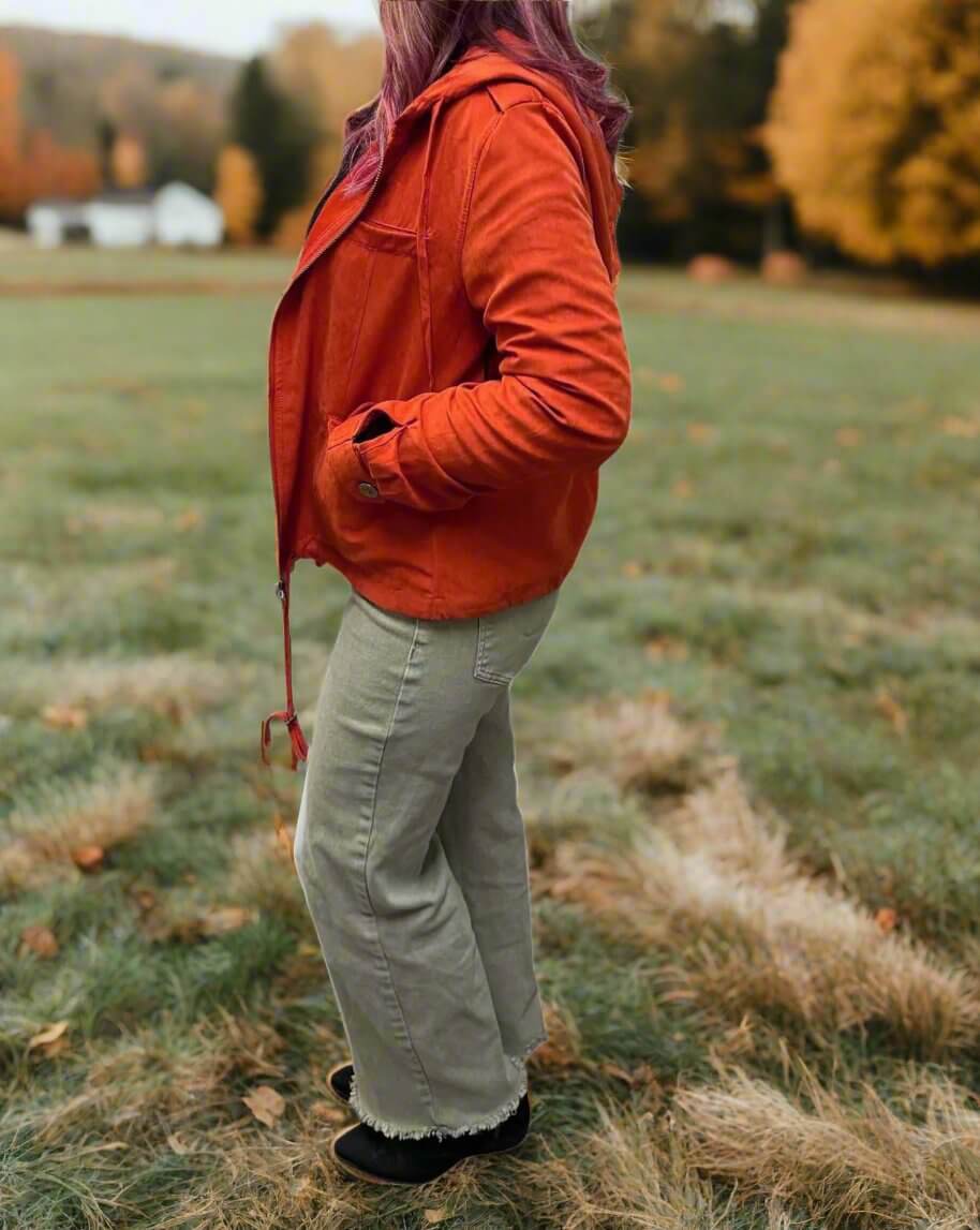 Model wearing Autumn Sunrise Jacket in ginger, showcasing stylish fall fashion in a scenic outdoor setting.
