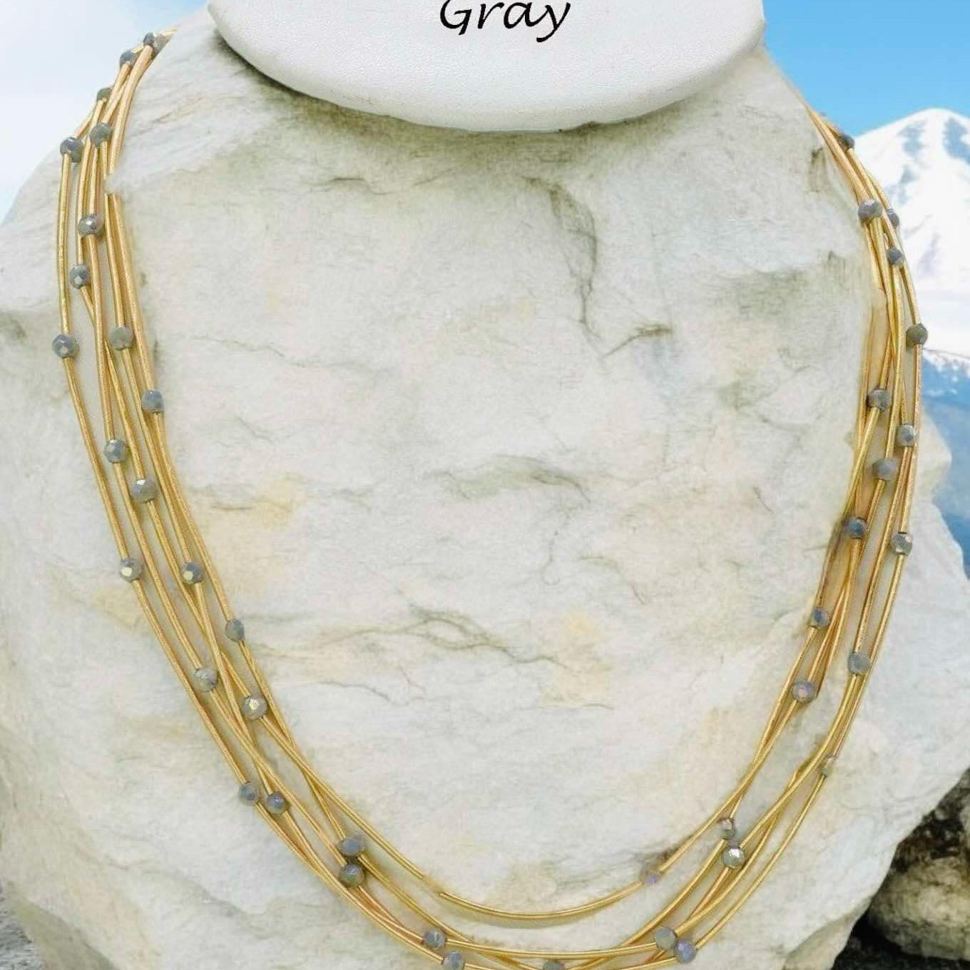 Gray Pretty Strands Necklace by Nine with gold tone multi strand and glass beads, 22 inches long, adjustable.