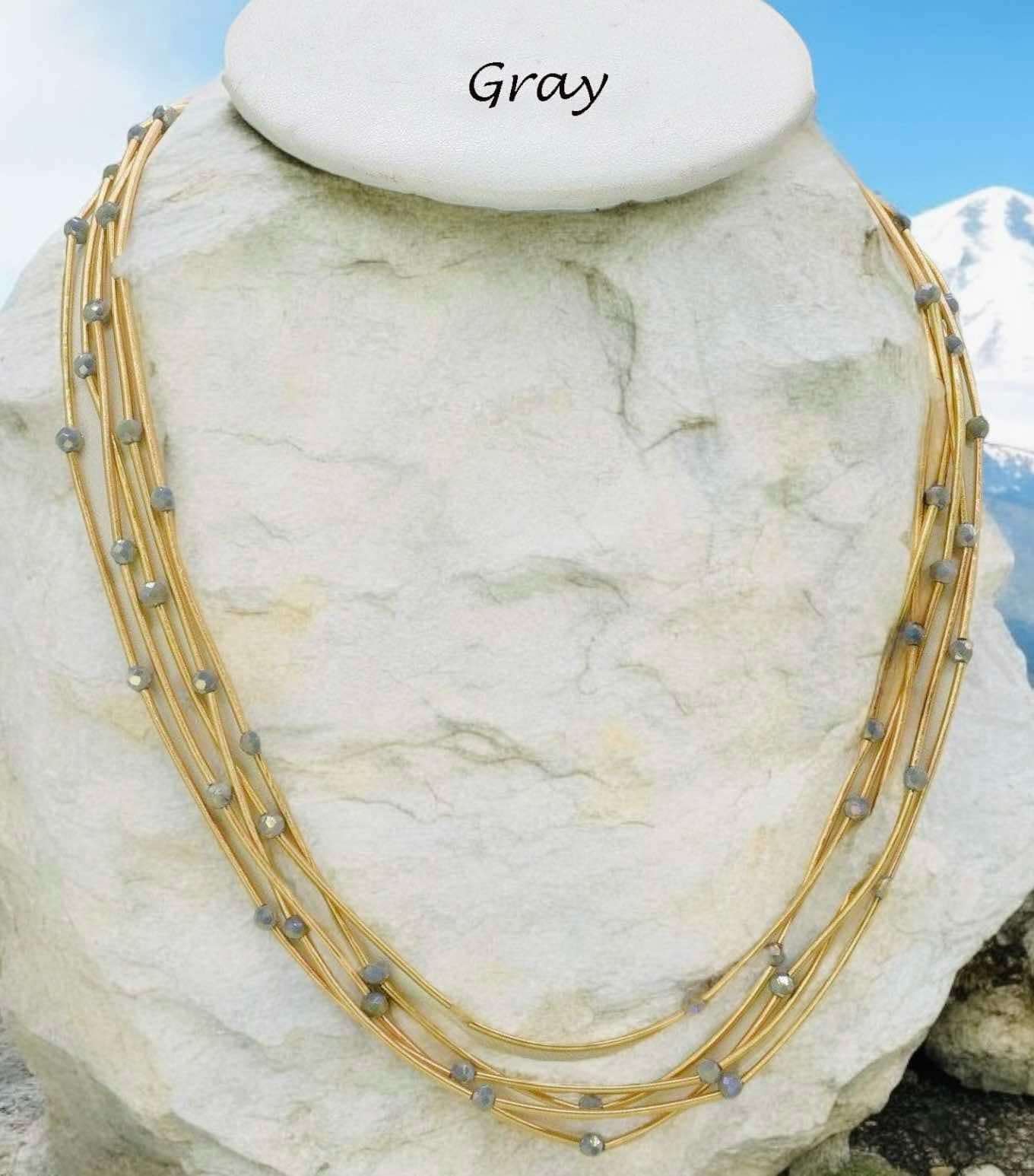 Gray Pretty Strands Necklace by Nine with gold tone multi strand and glass beads, 22 inches long, adjustable.