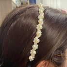 Pearl embellished hairband featuring intricate faux pearls for an elegant holiday accessory.