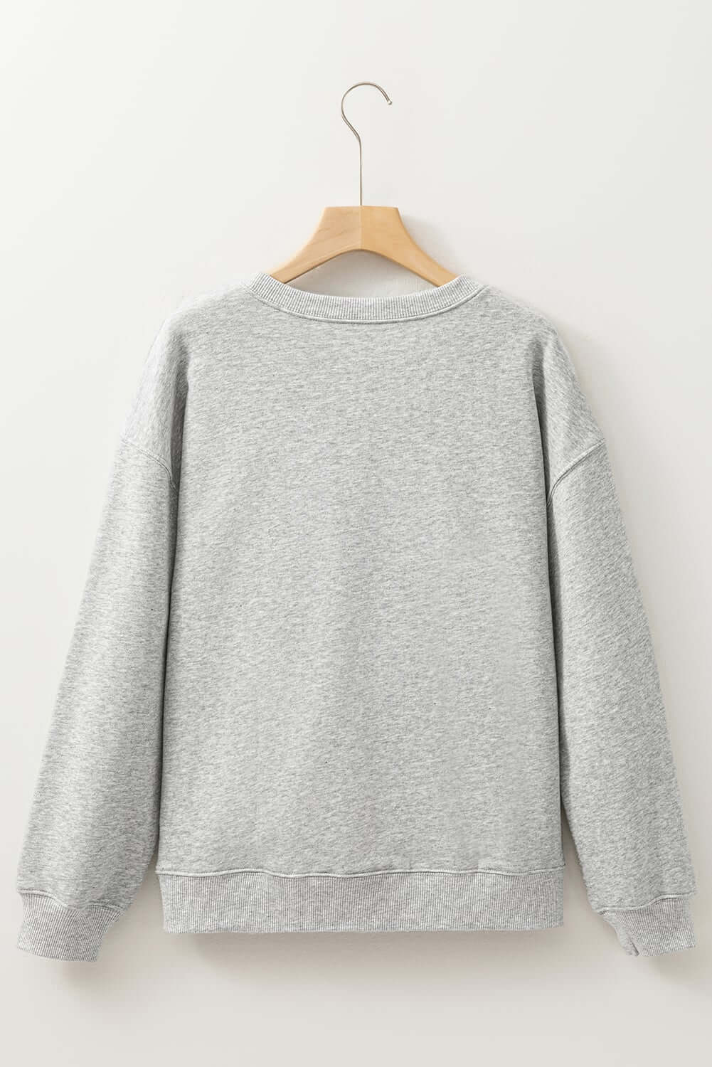 Back view of a grey baggy sweatshirt, perfect for holiday style and festive occasions.