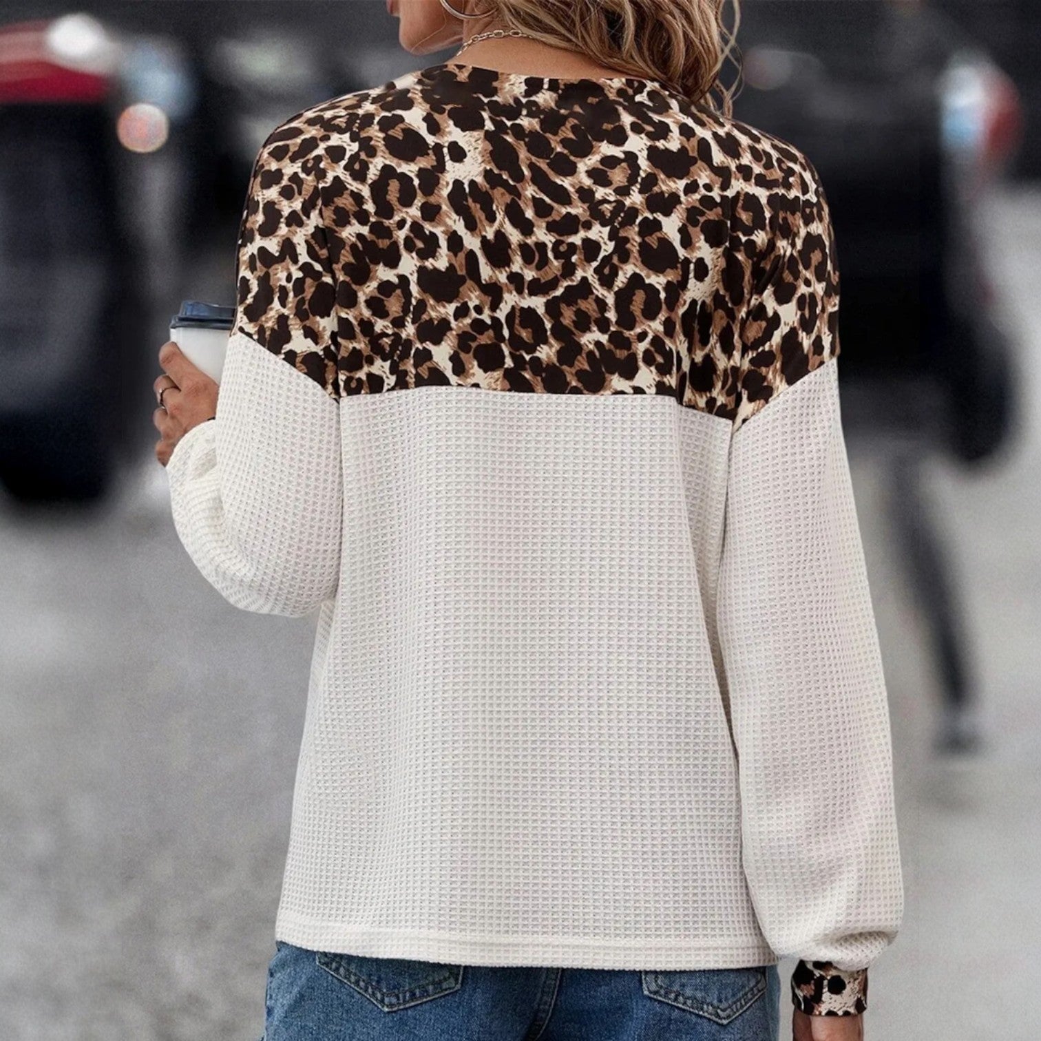 Chic Instincts Top featuring white waffle knit fabric and leopard print patchwork design, perfect for this weather.