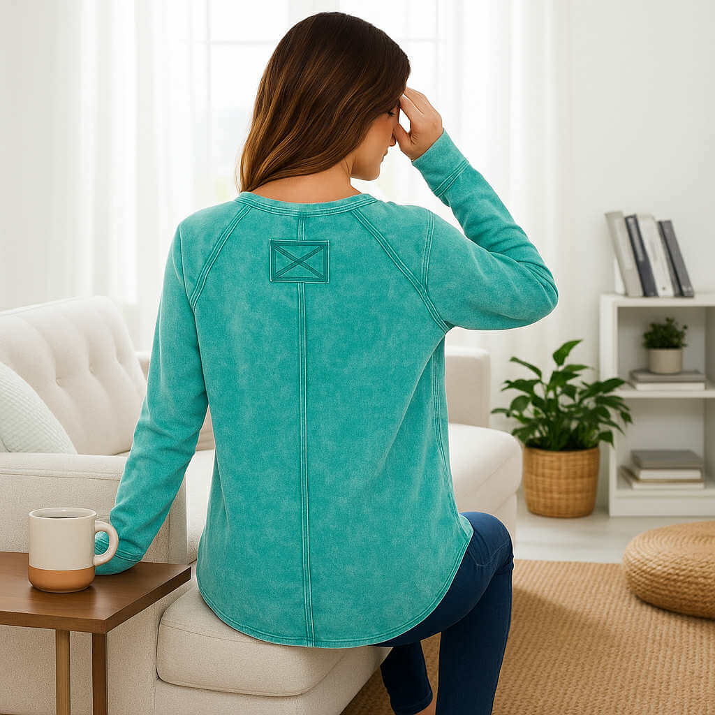 Back view of a woman wearing the Coastline Calm - Zenana (aqua), showcasing its soft mineral wash and thumbhole cuffs.