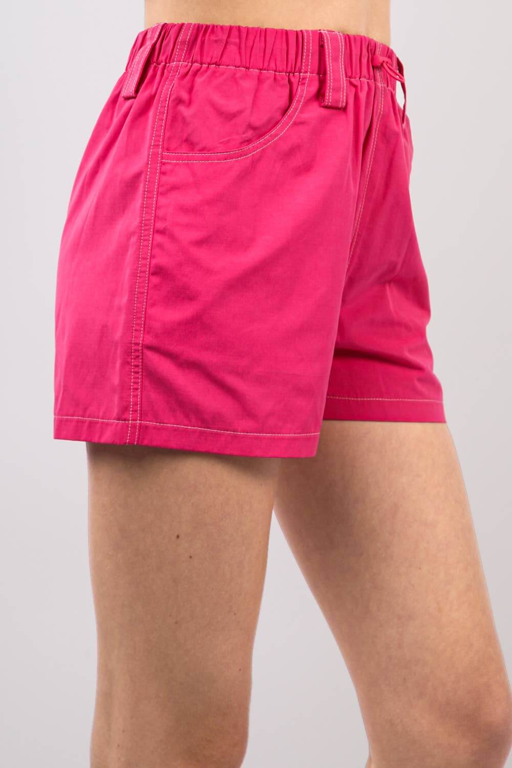 Hot pink relaxed fit shorts with an elastic waistband and adjustable drawstring for casual comfort.