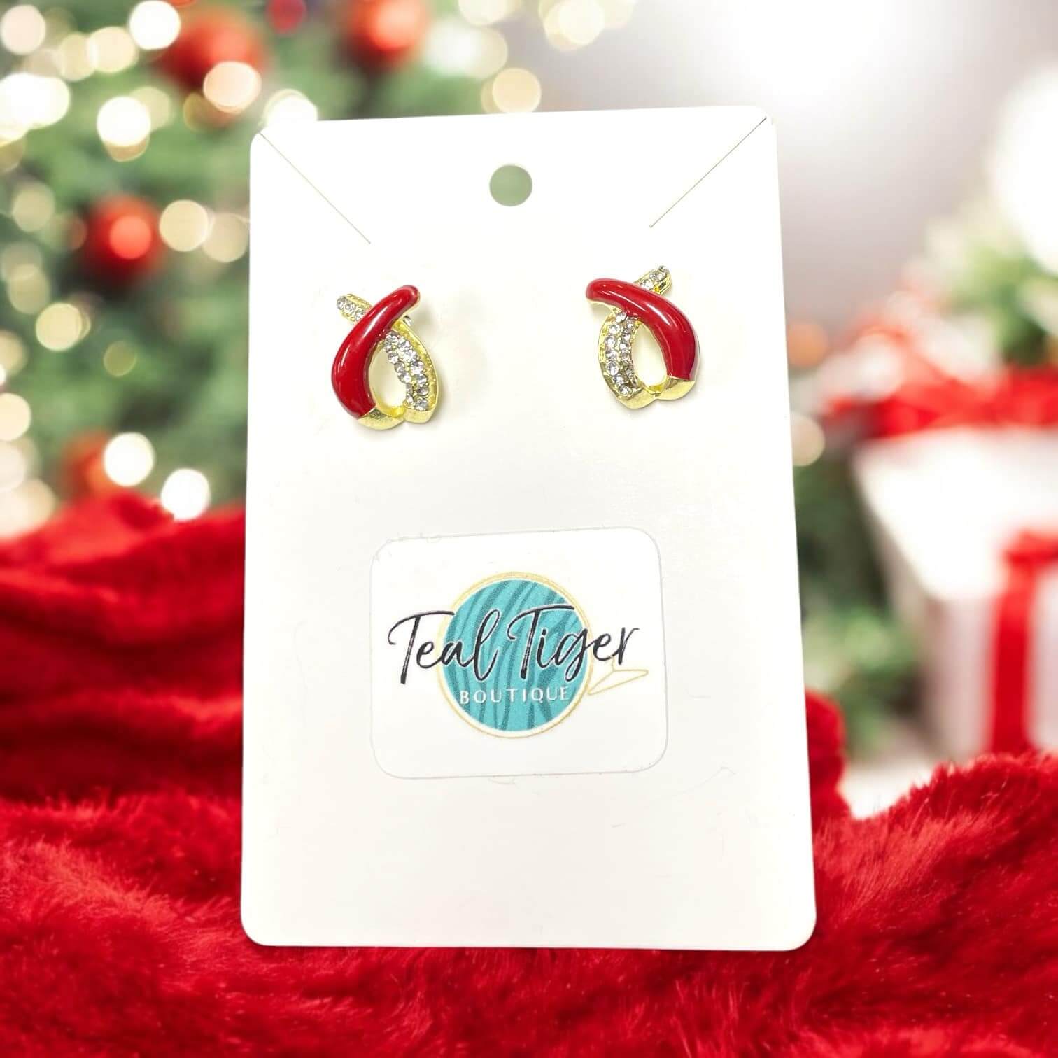 Elegant goldtone stud earrings with rhinestones and red accents, perfect for holiday outfits and festive occasions.