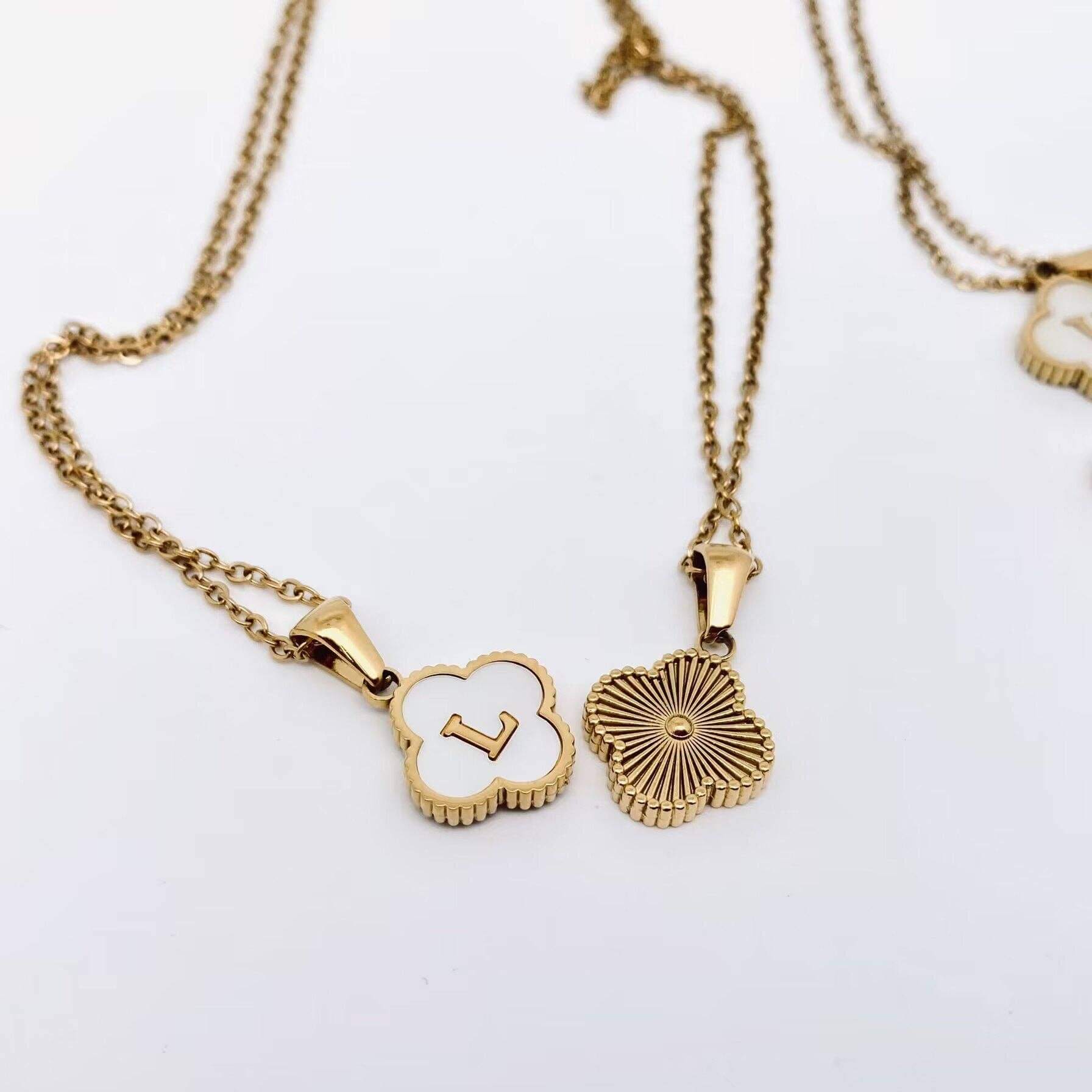 MONOGRAM MOMENTS NECKLACE featuring a gold floral pendant and initial 'L' on a delicate chain.