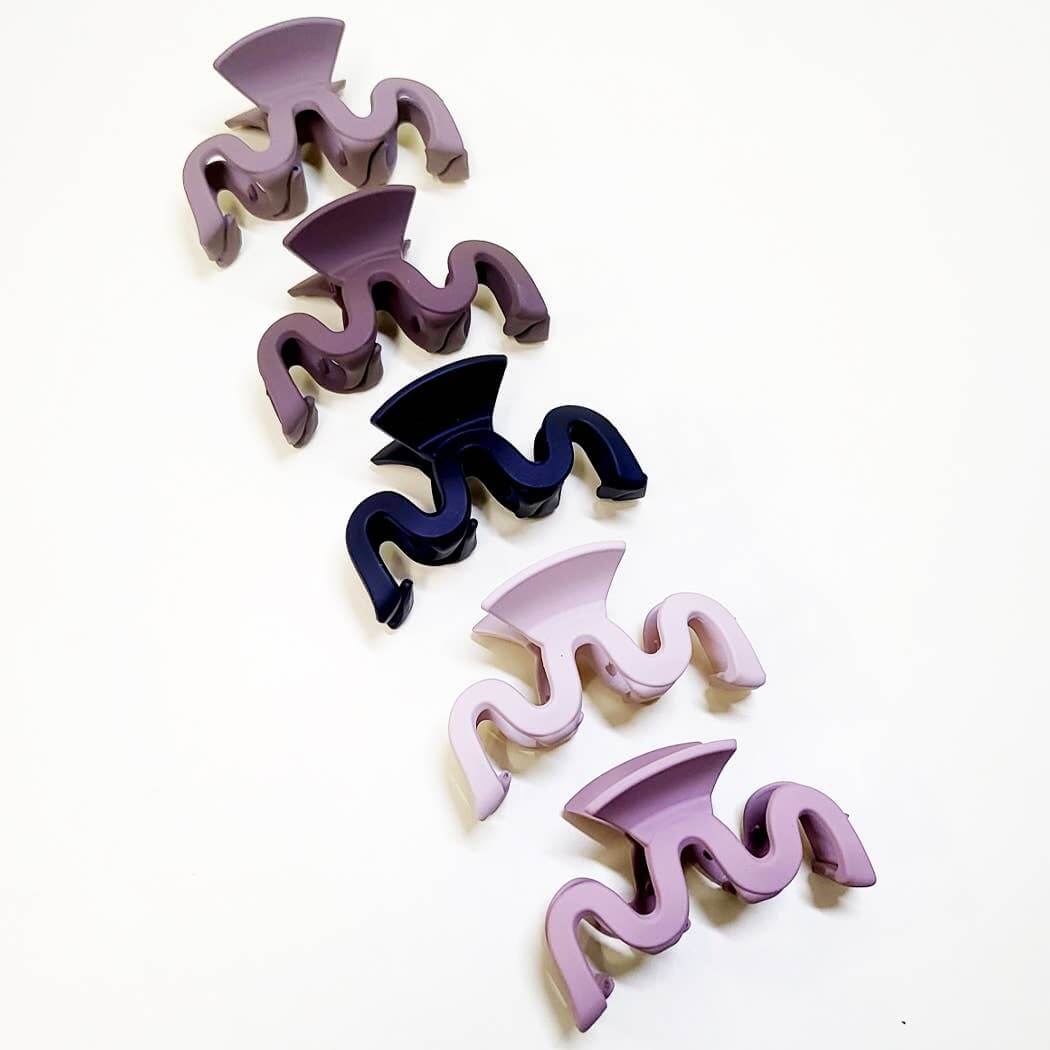 Set of 5 Curve Appeal hair claw clips in wavy design, showcasing matte finishes and trendy colors.