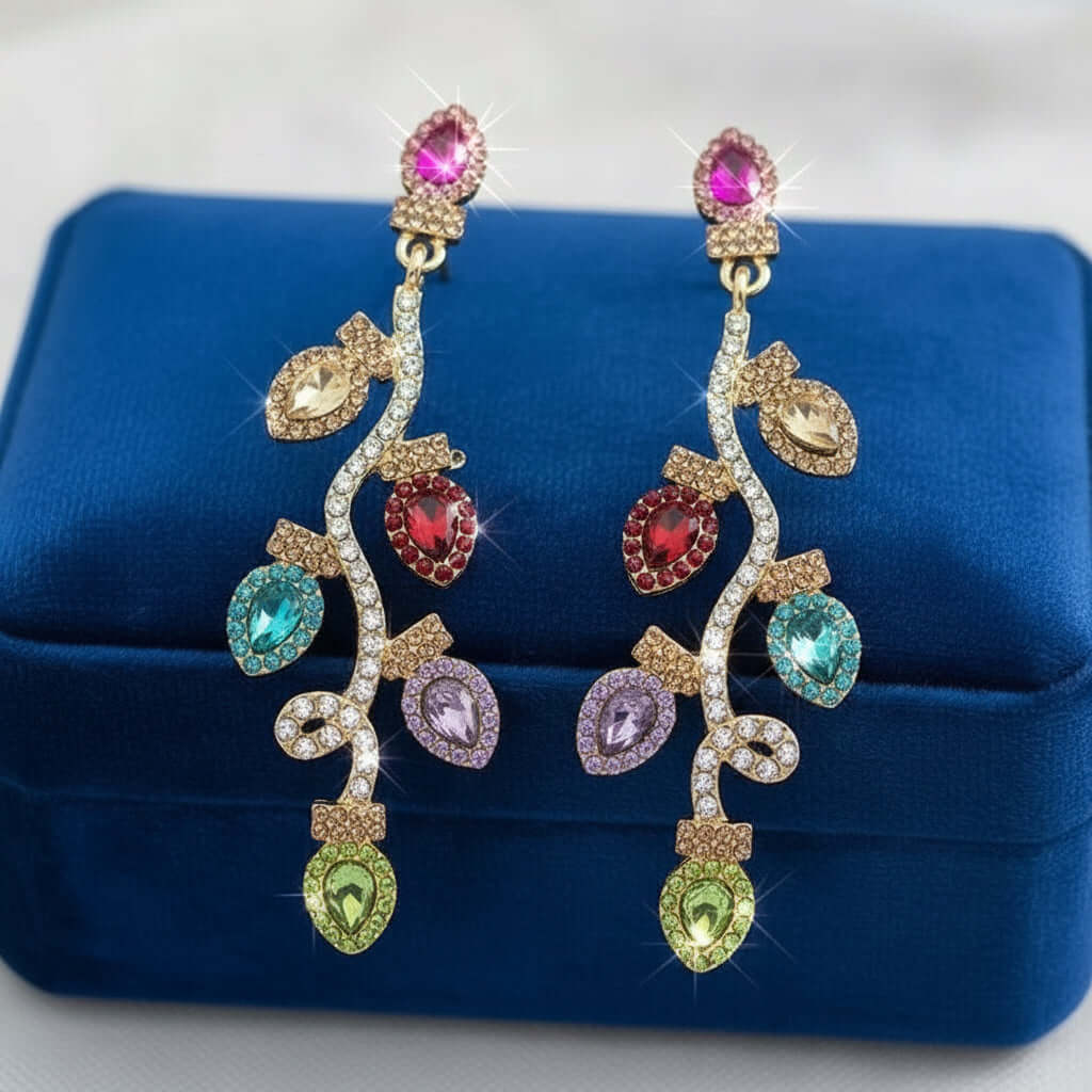 HOLIDAY CHEER LIGHT STRING EARRINGS featuring colorful jeweled dangle lights on a blue velvet box.