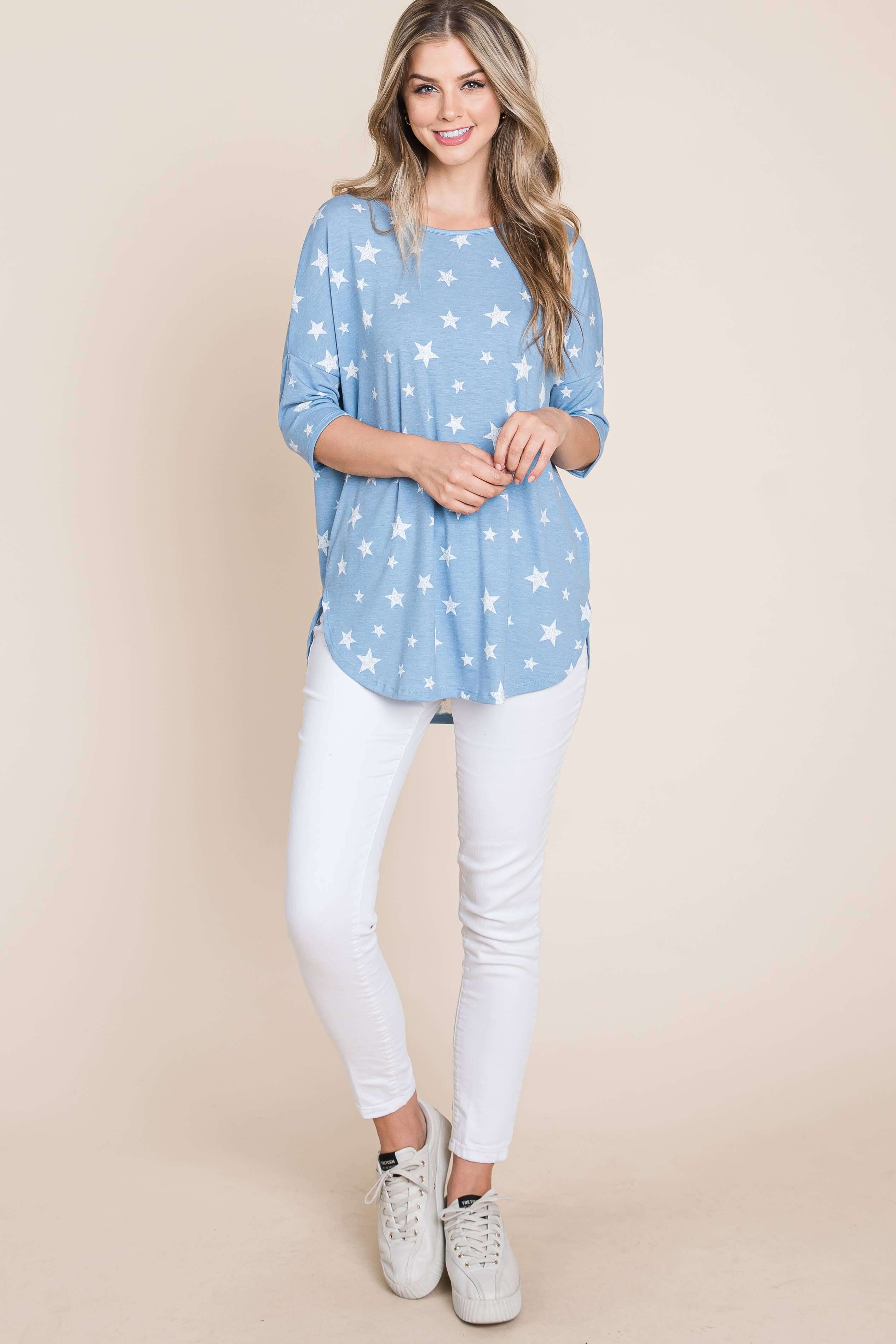 Blue star print tunic top with a relaxed fit, paired with white jeans, ideal for casual styling.