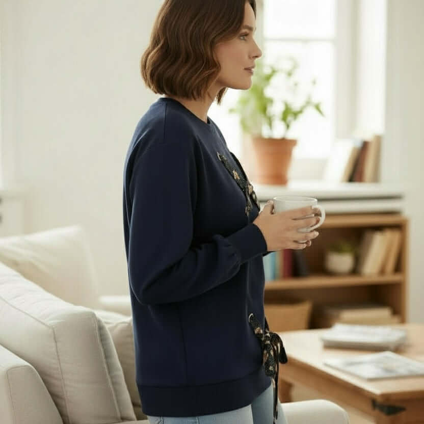 SOFT TIES Crewneck Pullover By Skies Are Blue worn by a woman in a cozy indoor setting, holding a cup.