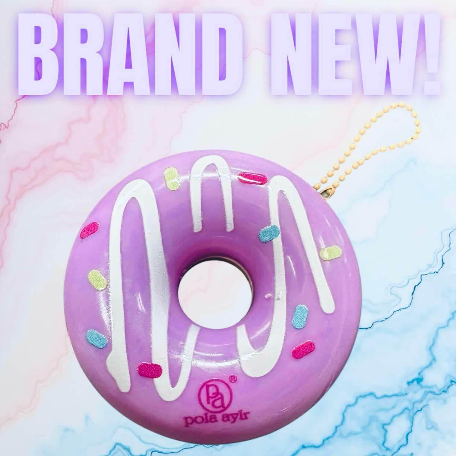 Donut Worry Lip Balm in purple with colorful sprinkles, attached to a keychain for easy use on-the-go.