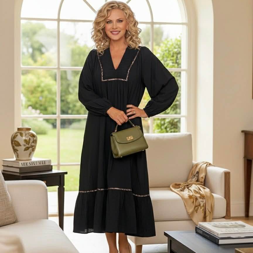 Model wearing GRACEFUL INSTINCTS MAXI DRESS with smocked detail and contrast leopard trim in a bright living room.