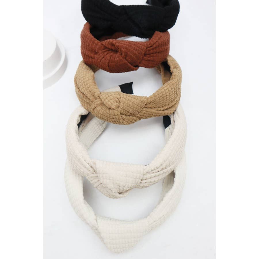 Knot Your Average Headband collection featuring four textured styles in black, rust, beige, and white.