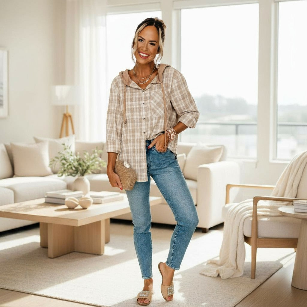 DRIFTWOOD DAYS BUTTON DOWN worn by a woman in a cozy living room, styled with loose fit jeans and a checkered print shacket.