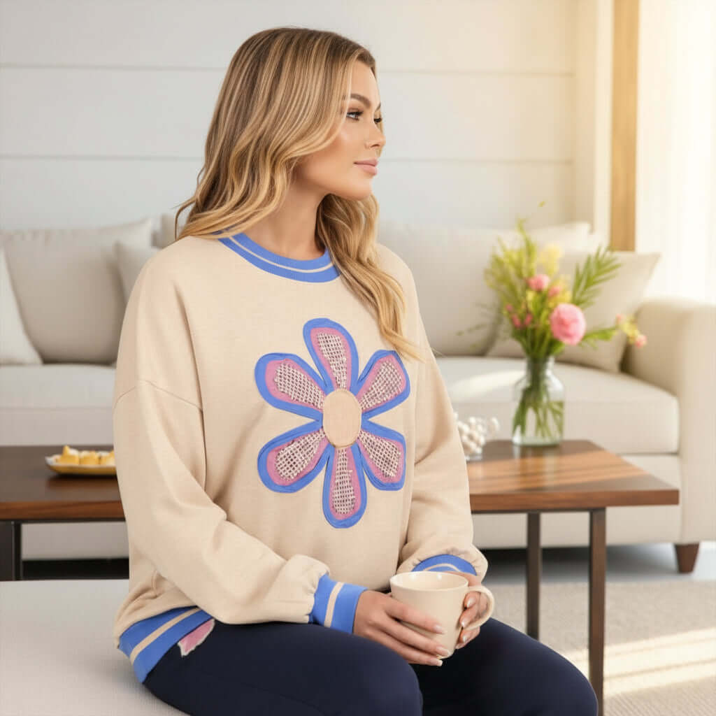 DAYDREAM BELIEVER - Sage + Fig (beige) model wearing oversized crew neck pullover with daisy design, relaxed fit.