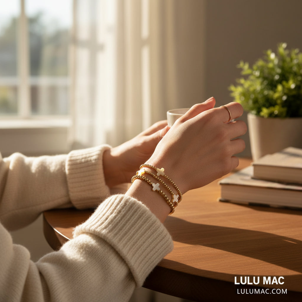 LULU MAC - GOLDEN GRACE BRACELET SET worn on a hand while holding a cup, showcasing its elegant design.