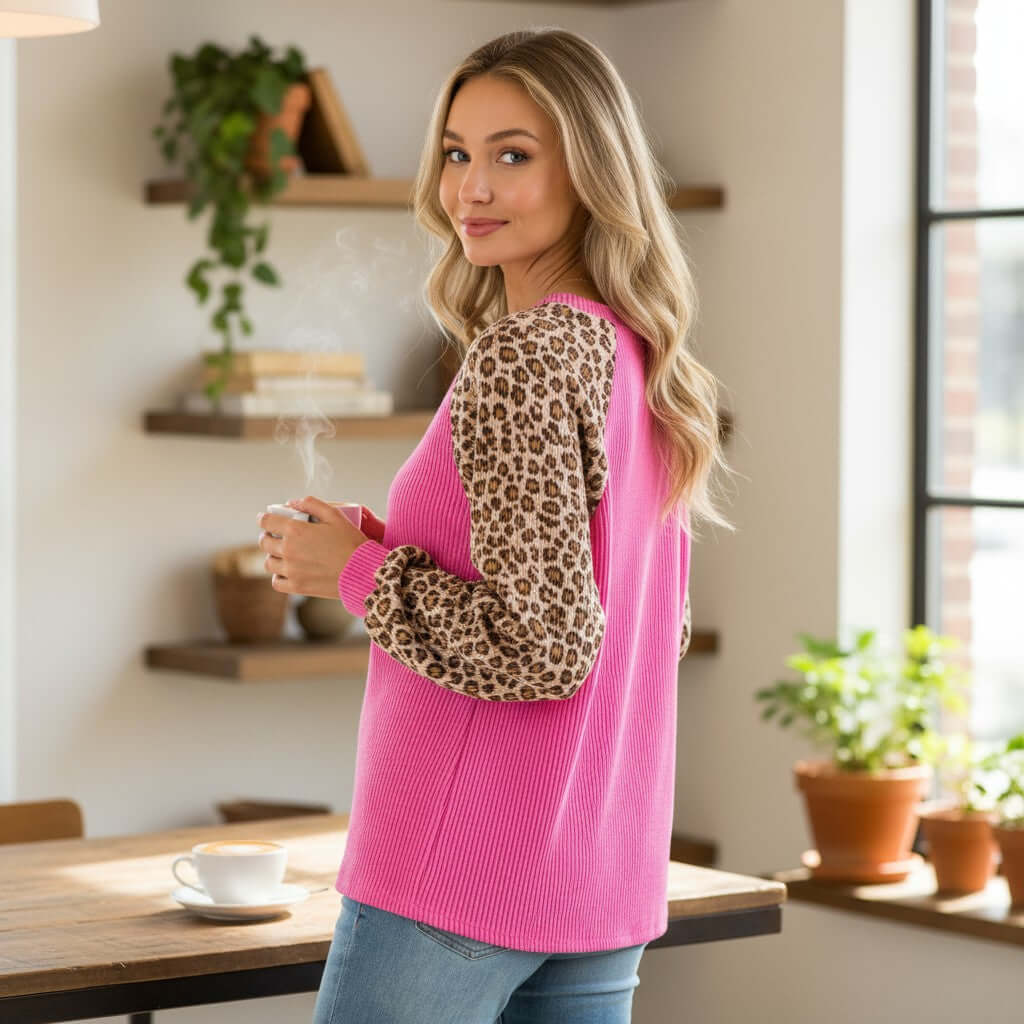 WILD CRUSH TOP - Lovely Melody model wearing pink top with leopard sleeves, enjoying coffee in cozy setting.