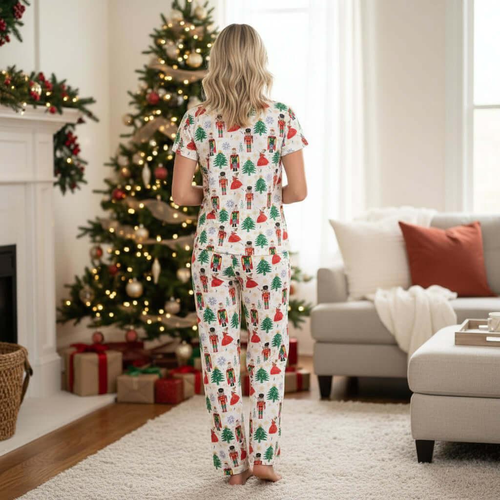 Cozy Nutcracker Noel Pajamas featuring festive Christmas print, perfect for holiday lounging in front of a decorated tree.