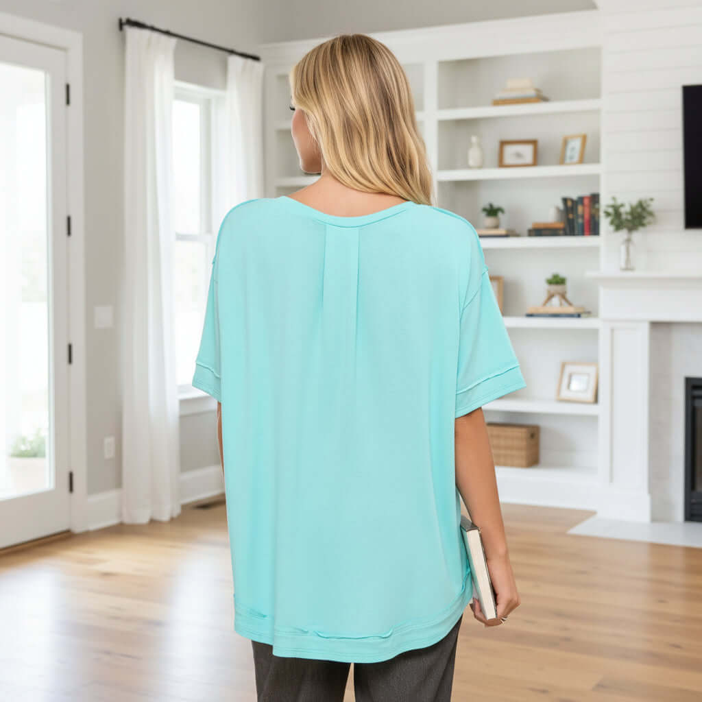 Back view of the CALM COLLECTIVE TOP - Andree' (aqua) showcasing its relaxed fit and soft texture.