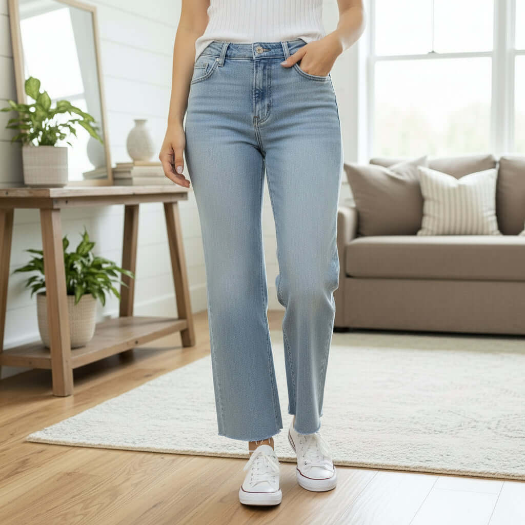 Model wearing ZELDA WIDE LEG JEANS by Vervet in a cozy living room setting, showcasing the chic design and cropped silhouette.