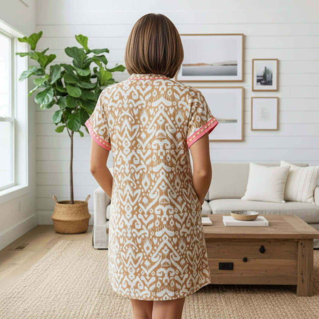 Back view of the BOARDWALK BELLE DRESS showcasing its modern mini design and striking fashion print.