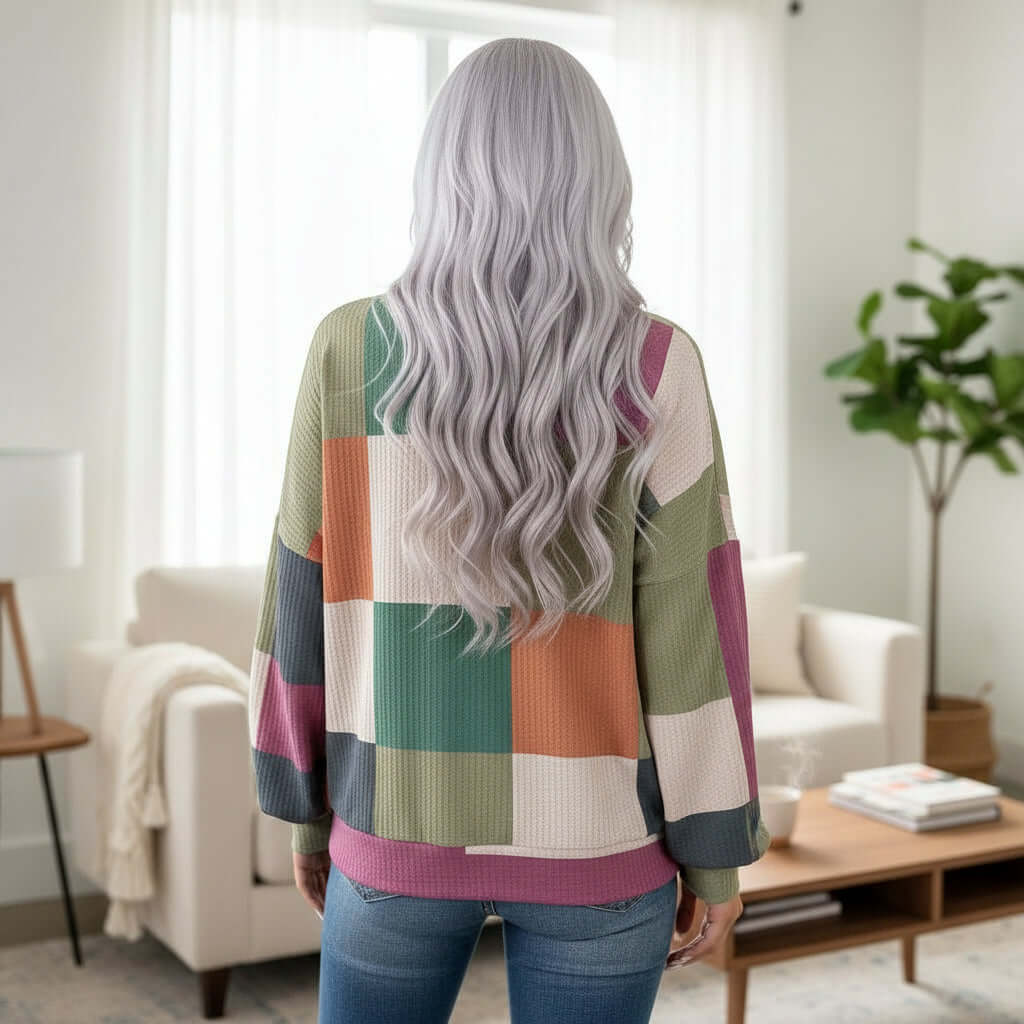 Back view of a model wearing the CHECK MIXED TOP, showcasing its colorful checkered design and loose fit.