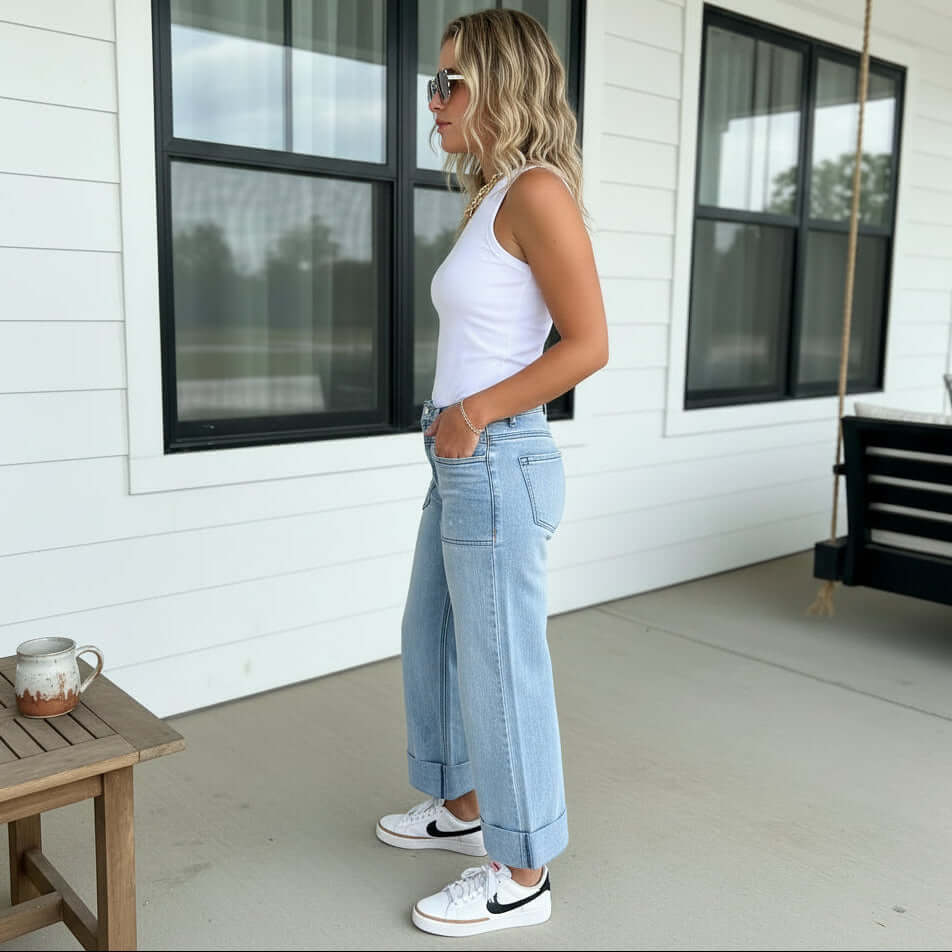 Model showcasing BLAKELY CLOVER FRONT POCKET JEANS in a casual setting with a white tank top.