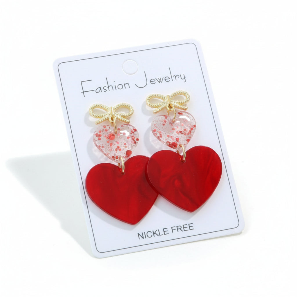 FOREVER YOURS EARRINGS with glossy red acrylic hearts and gold-tone bows on a fashion jewelry card.