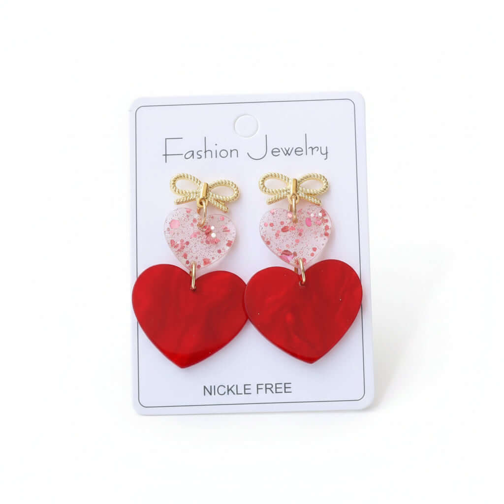 CHERISHED HEARTS EARRING featuring glossy red heart drops and a gold-tone bow, perfect for Valentine's Day and romantic wear.