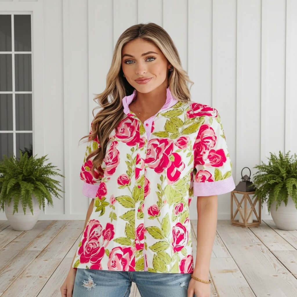 Model wearing SPRING STATEMENT TOP with vibrant floral print and striped trim, showcasing a stylish collar.