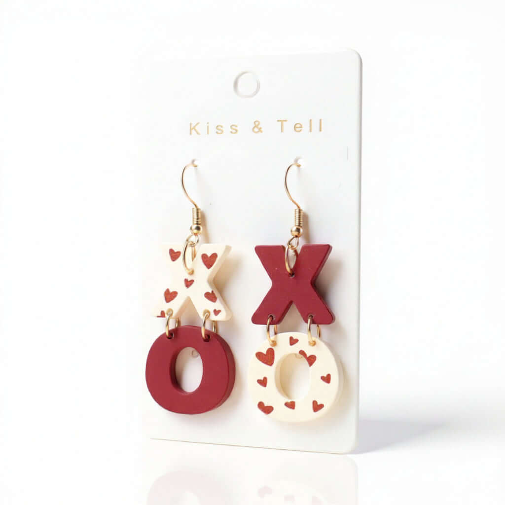 KISS & TELL EARRINGS featuring XO heart print dangle design in red and white, perfect for a flirty Valentine's vibe.