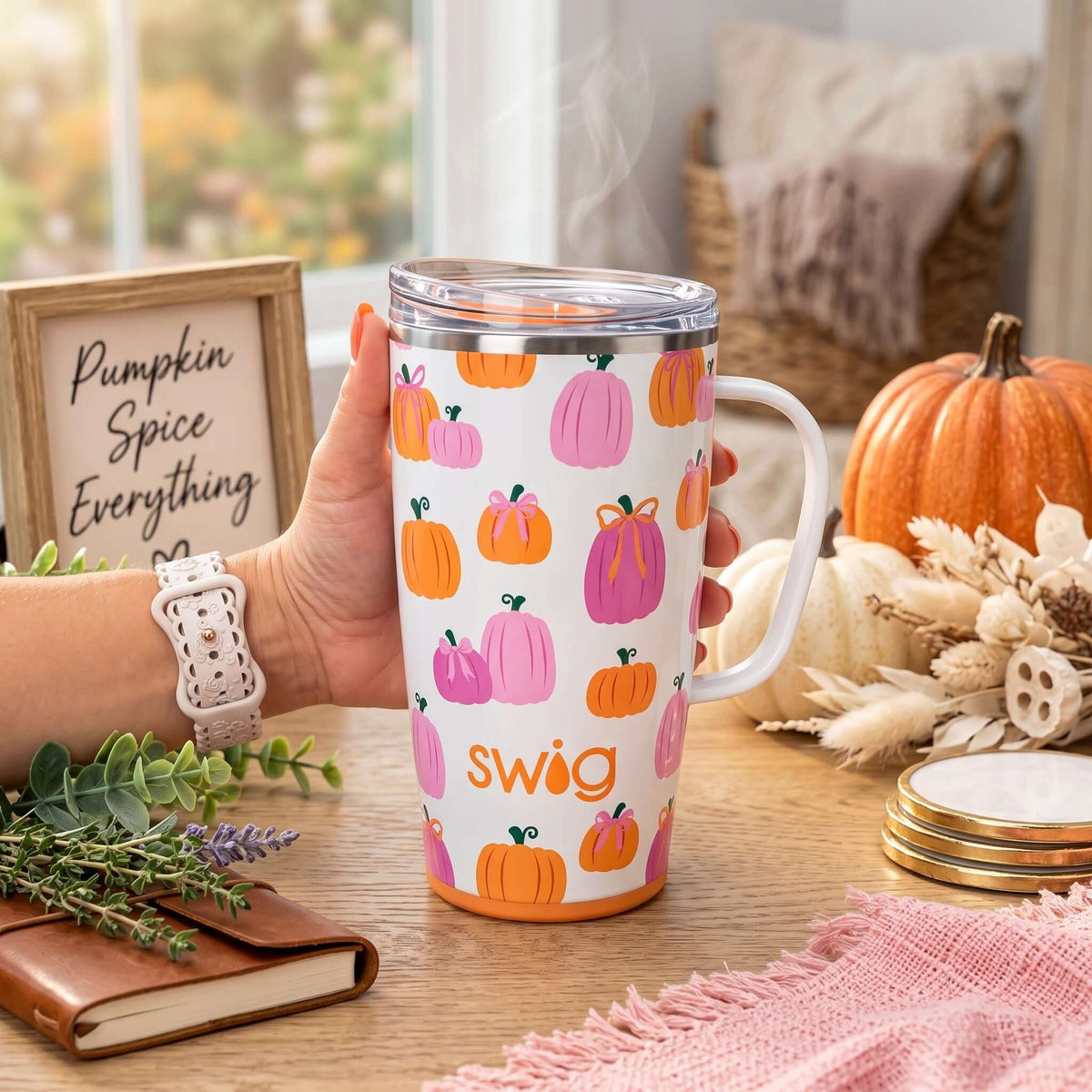 PUMPKINS & BOWS TRAVEL MUG with pink and orange pumpkins on a white background held in a hand, perfect for fall drinks.