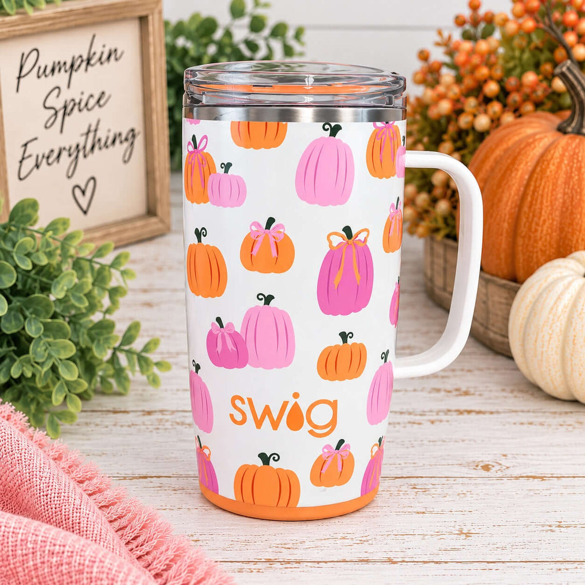 PUMPKINS & BOWS TRAVEL MUG displayed beside pumpkins and foliage for a cozy fall vibe.