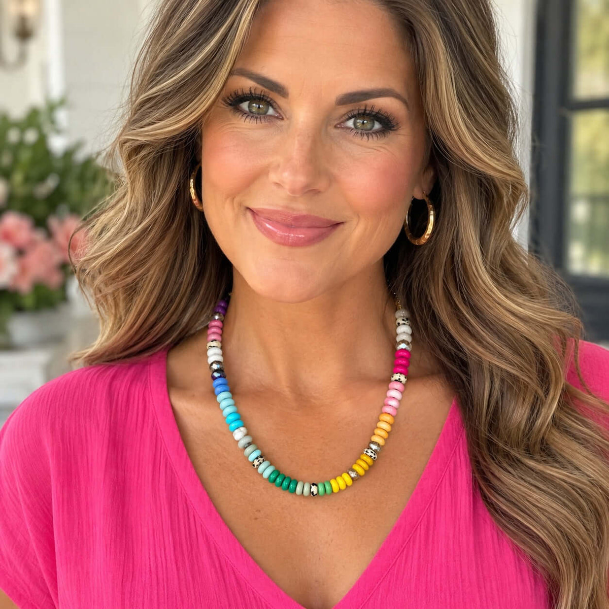 Color Me Happy Necklace worn by a woman with long hair in a pink top, featuring colorful beads and leopard-print accents.