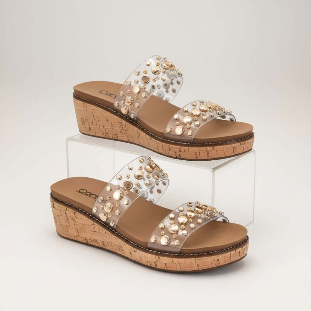 CORKYS - YES PLEASE CLEAR/GOLD WEDGES with transparent straps and gold studs on a cork wedge sole.