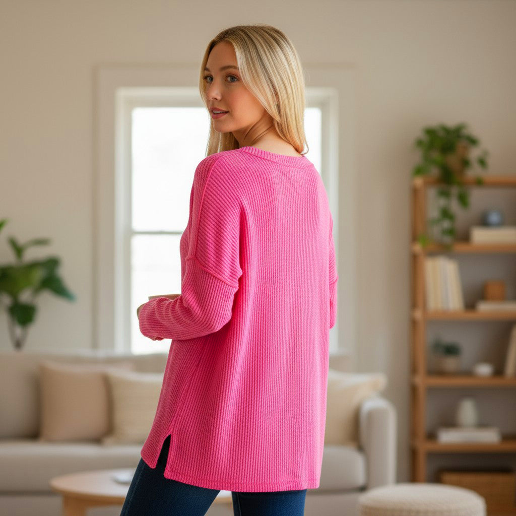 Woman in a cozy pink top showcasing the COZY CONCEPTS RIBBED TOP (hot pink) in a relaxed fit and hi-low hem.