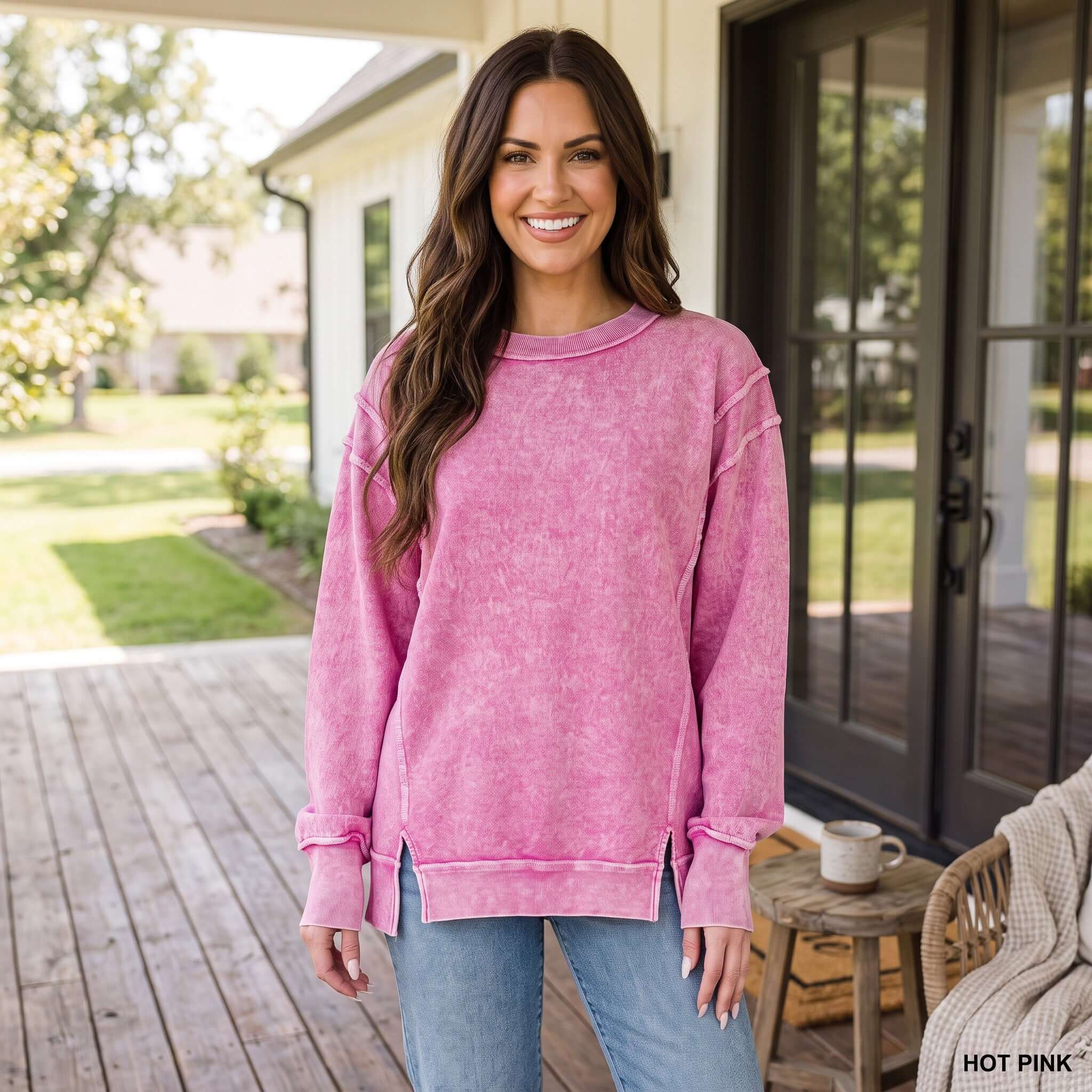 WEEKEND COZY PULLOVER (3 colors) in hot pink worn by a smiling woman on a porch, perfect for relaxed outfits.
