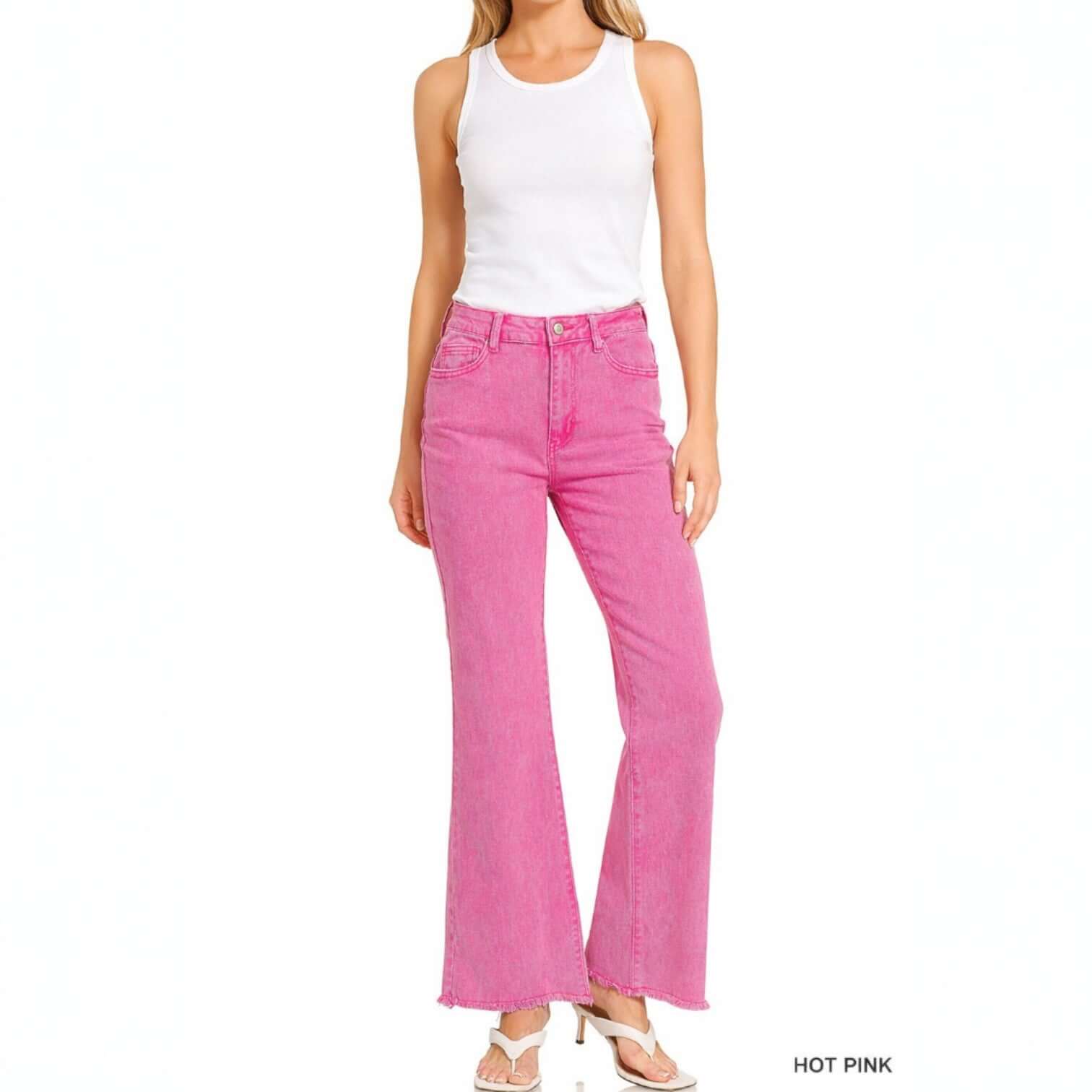 COLOR CRUSH DENIM - Zenana model wearing hot pink acid-washed wide leg jeans with frayed hem.