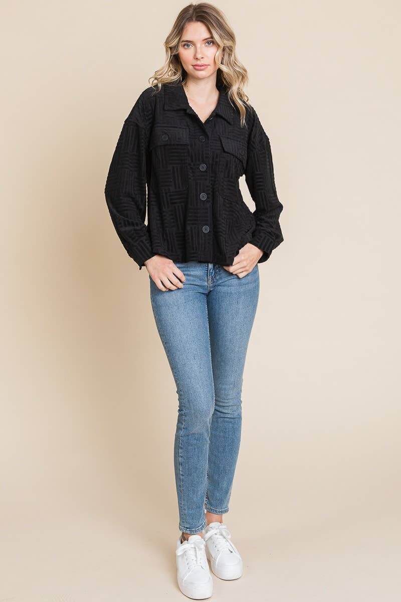 Women wearing a black embossed soft casual shacket with button-down front, paired with blue jeans and white sneakers.