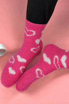 Cozy pink Heart's Delight Socks with heart-shaped patterns, perfect for adding warmth and style to your outfit.