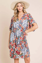 Woman wearing the DA1475 floral wrap V-neck midi dress, showcasing a relaxed fit and flowy fabric.